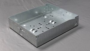 Formed steel electrical box with knockouts, from Perry Tool & Die in Broomfield, Colorado